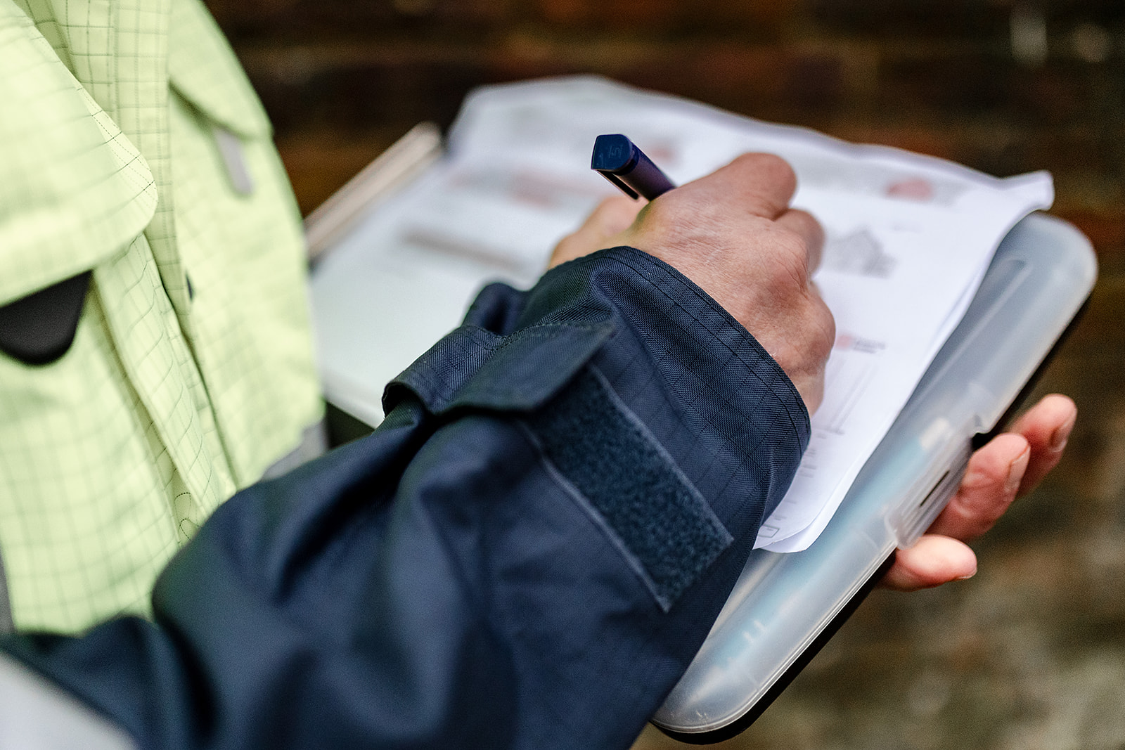 man making notes on an asbestos survey